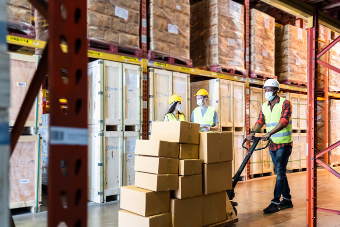 Group of diversity Workers wearing protective face mask working in factory warehouse.
