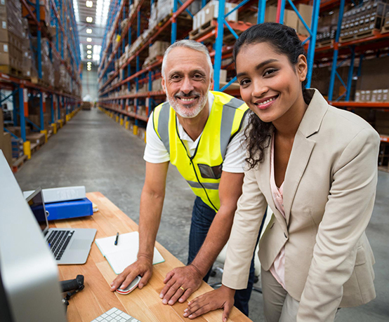 Portrait of warehouse manager and worker working together in warehouse office